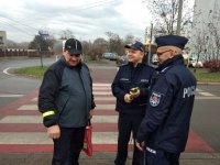 na zdjęciu: policjanci wręczają odblask mieszkańcowi Łazisk Górnych